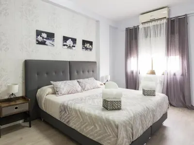 a bedroom with a bed with two lamps on it at Click&Flat Xoriguer in Barcelona
