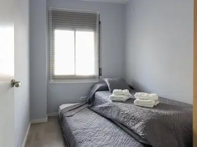 a bedroom with a bed with two towels on it at Click&Flat Xoriguer in Barcelona