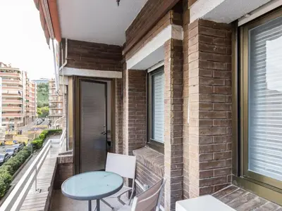 a balcony with a table and chairs and a window at Click&Flat Xoriguer in Barcelona