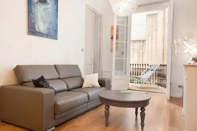 a living room with a couch and a table at LUXURY BARCELONA CENTRAL CITY COSY 3 BEDROOM APARTMENT WITH PRIVATE TERRACE in Barcelona