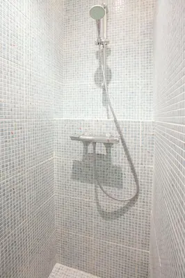 a shower in a bathroom with white tiles at LUXURY BARCELONA CENTRAL CITY COSY 3 BEDROOM APARTMENT WITH PRIVATE TERRACE in Barcelona