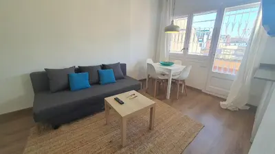 a living room with a couch and a table at Opening Doors Sagrada Familia in Barcelona