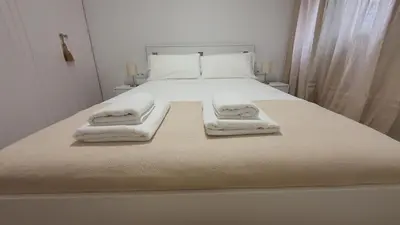 a bedroom with a bed with two towels on it at Opening Doors Sagrada Familia in Barcelona