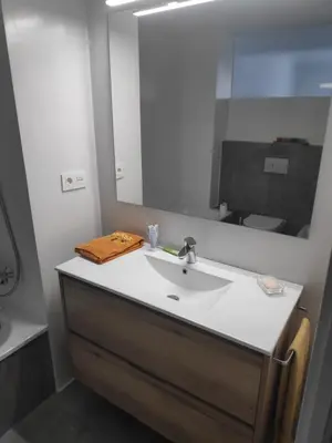 a bathroom with a sink and a mirror at Apartment with a view close to the beach in Badalona