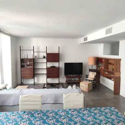a living room with two beds and a flat screen tv at Apartment with a view close to the beach in Badalona