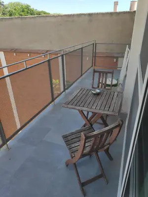 a table and a chair on a balcony at Apartment with a view close to the beach in Badalona