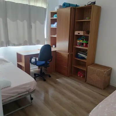 a bedroom with a desk and a bed and a chair at Apartment with a view close to the beach in Badalona