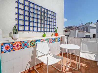 a balcony with two chairs and a table at Sebastian Terrace Apartment by Hello Homes Sitges in Sitges