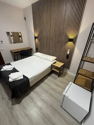a hotel room with a bed and a table at COLIBRI in Calella