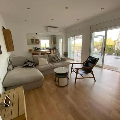a living room with a couch and a table at Villa Maioli in Olivella