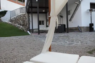 a white bench in front of a building at Villa Maioli in Olivella