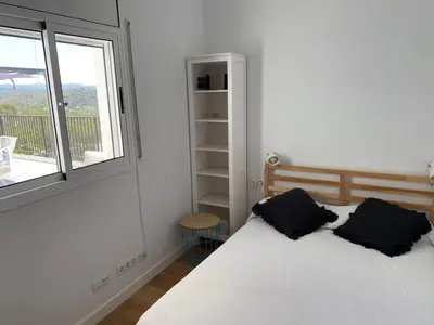 a bedroom with a bed with two pillows on it at Villa Maioli in Olivella