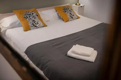 a large bed with a white towel on it at Seneca7 near paseo de gracia in Barcelona