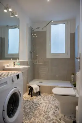 a bathroom with a toilet and a washing machine at Seneca7 near paseo de gracia in Barcelona