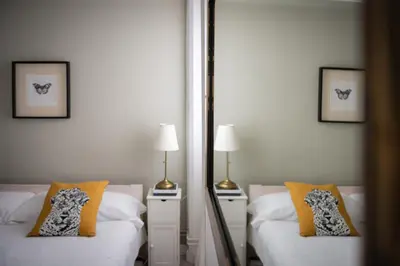 a bedroom with two beds and a mirror at Seneca7 near paseo de gracia in Barcelona