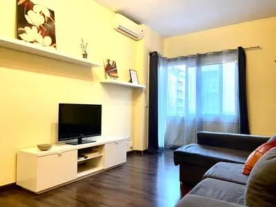 a living room with a tv and a couch at APARTAMENTO BARCELONA in Barcelona