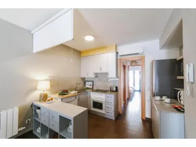 a kitchen with white cabinets and a counter top at Sitges Spaces Deluxe Beach Apartment- 3 Bedroom, 2 Bathroom, Next to Beach, Sleeps 6 in Sitges