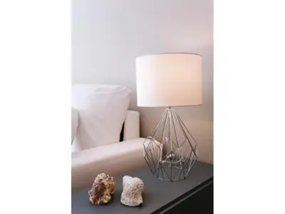 a lamp on a table next to a bed with some rocks at Sitges Spaces Deluxe Beach Apartment- 3 Bedroom, 2 Bathroom, Next to Beach, Sleeps 6 in Sitges