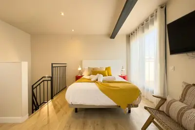 a bedroom with a bed with a yellow blanket at Barcelona Touch Apartments - Progres in Hospitalet de Llobregat