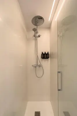 a bathroom with a shower with a glass door at Barcelona Touch Apartments - Progres in Hospitalet de Llobregat