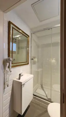 a bathroom with a shower and a sink and a mirror at Barrio Gotico Apartments Ferran in Barcelona