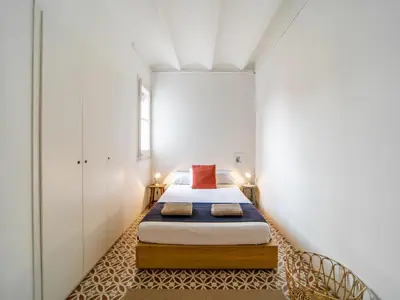 a small bedroom with a bed in a room at White penthouse in Barcelona