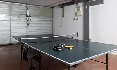 a ping pong table in a room with a ping pong racket at Stay U-nique Villa Portimar in Arenys de Mar