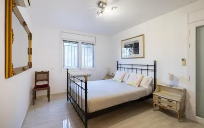 a bedroom with a bed and a chair at Stay U-nique Villa Portimar in Arenys de Mar