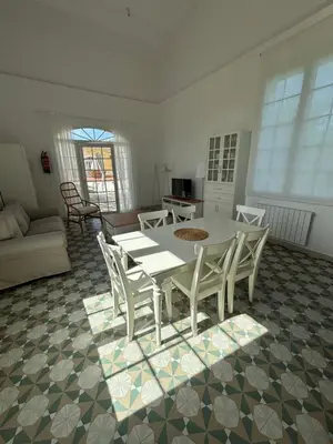 a living room with a white table and chairs at Bio Resort Mediterráneo in San Martín Sarroca