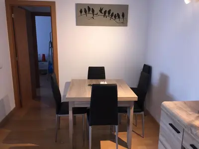 a dining room table and chairs in a room at APARTAMENTO construcción nueva BARCELONA - CALELLA in Calella