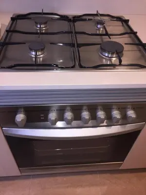 a stove top oven sitting in a kitchen at APARTAMENTO construcción nueva BARCELONA - CALELLA in Calella