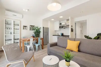 a living room with a couch and a table at Sitges Group Blue&White in Sitges