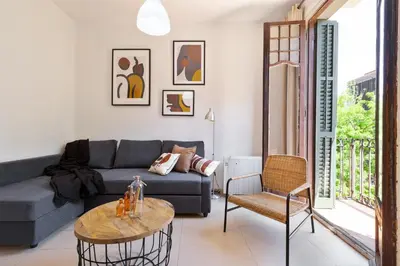a living room with a couch and a table at Stay U-nique Apartments Mistral in Barcelona