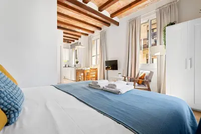 a bedroom with a bed with two towels on it at Lodging Apartments Barceloneta Beach Studio 32 in Barcelona