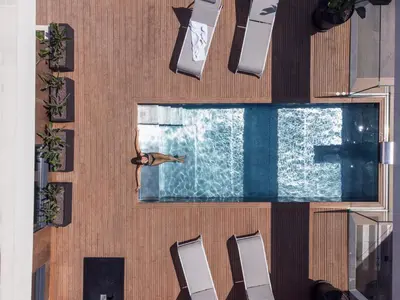 a pool on a cruise ship with a bird flying over it at Art Apartments BCN in Castelldefels