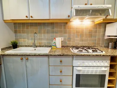 a kitchen with a sink and a stove at Apartamento Burdeos by Hello Homes Sitges in Sitges