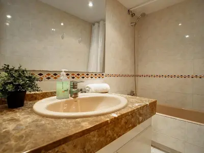 a bathroom with a sink and a shower at Apartamento Burdeos by Hello Homes Sitges in Sitges