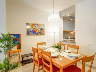 a dining room with a wooden table and chairs at Apartamento Burdeos by Hello Homes Sitges in Sitges