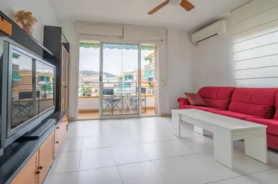 a bathroom with a sink and a tub and a mirror at HomeHolidaysRentals Margot - Costa Barcelona in Pineda de Mar