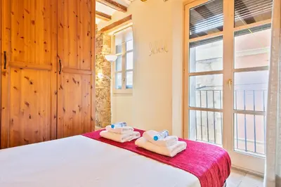 a bedroom with a bed with towels on it at Alcam Santa Monica in Barcelona