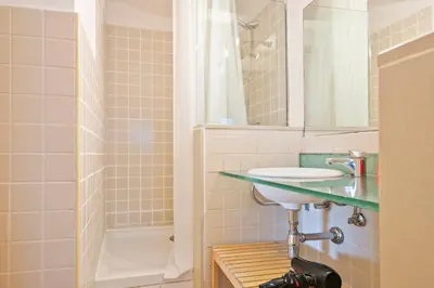 a bathroom with a sink and a shower at Alcam Santa Monica in Barcelona
