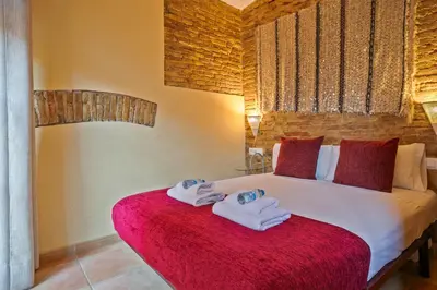 a bedroom with a bed with towels on it at Alcam Santa Monica in Barcelona