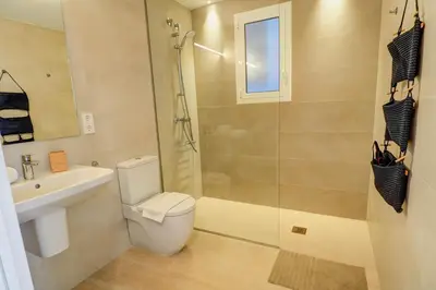 a bathroom with a toilet and a shower and a sink at Sebastian Patio by Hello Homes Sitges in Sitges