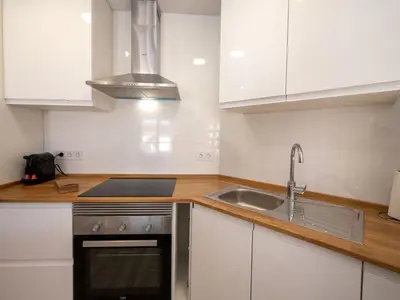 a kitchen with white cabinets and a sink and a stove at Apartment Blue Sea by Interhome in Cunit