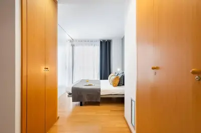 a bedroom with a bed and a room with a window at Lodging Apartments Monumumental in Barcelona