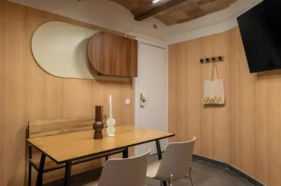 a dining room with a wooden table and chairs at Collblanc Apartment by Olala Homes in Hospitalet de Llobregat