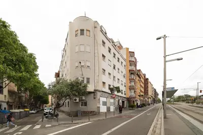 a tall white building on the side of a street at Collblanc Apartment by Olala Homes in Hospitalet de Llobregat