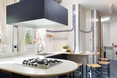 a kitchen with a stove and a white counter top at El Chalet del Montseny in Seva