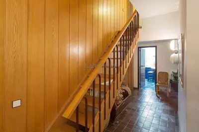 a staircase in a home with wooden walls at El Chalet del Montseny in Seva