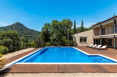 a swimming pool in the backyard of a house at Mediterranean villa with pool near barcelona in Cabrera de Mar